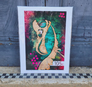 Flamingo skull inspired artwork, cellophane wrapped resting against blue painted doors and standing on a beige floor with black and white checker board stripe